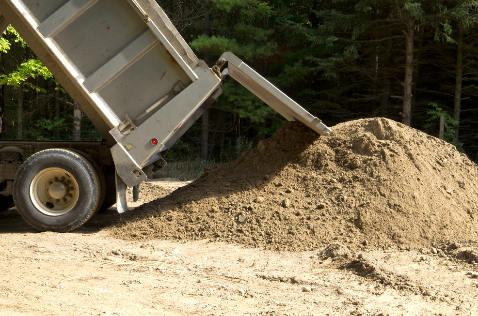Dump Truck Dumping Sand at Construction Site